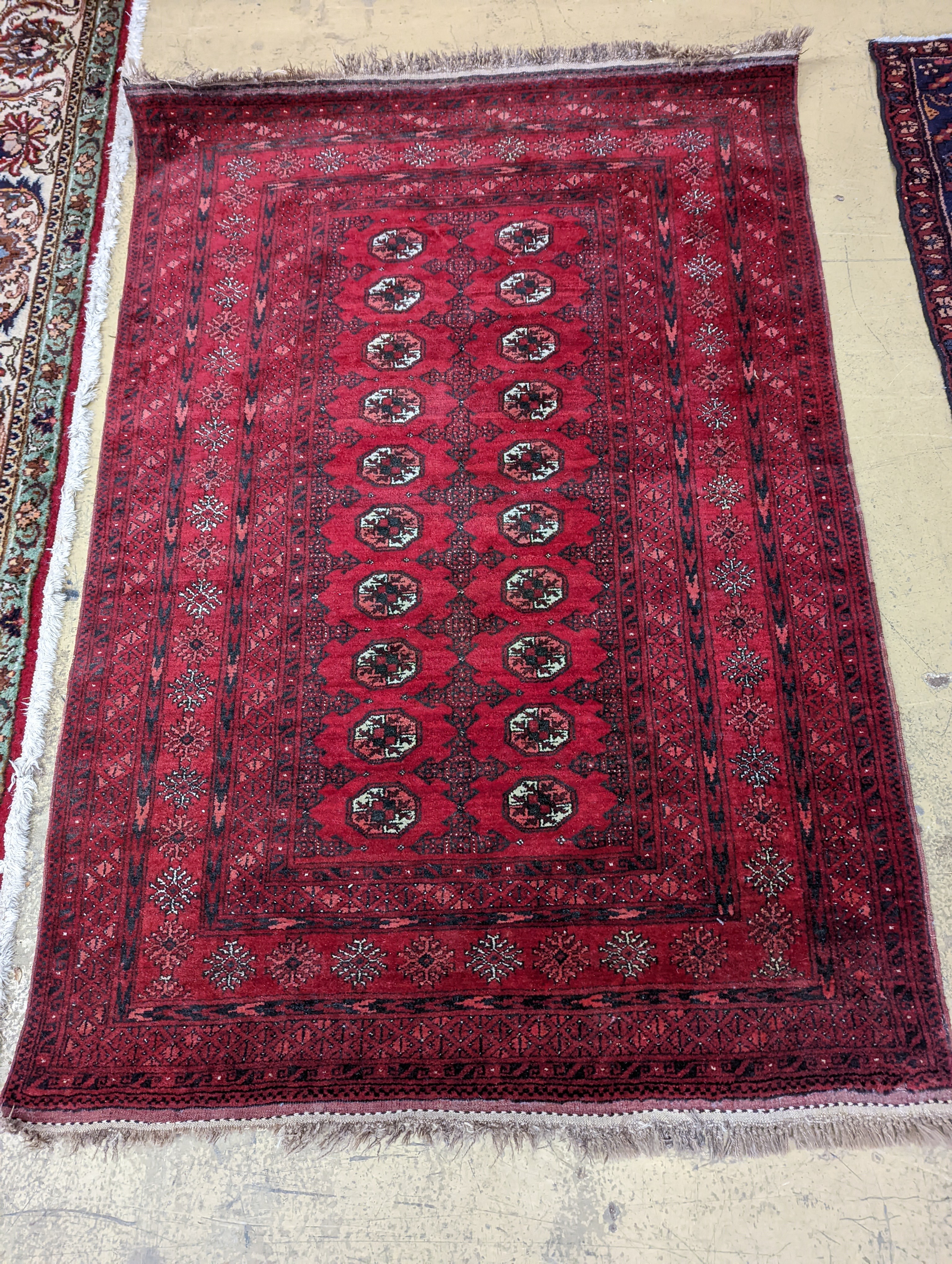 A Bokhara burgundy ground rug, 190 x 130cm
